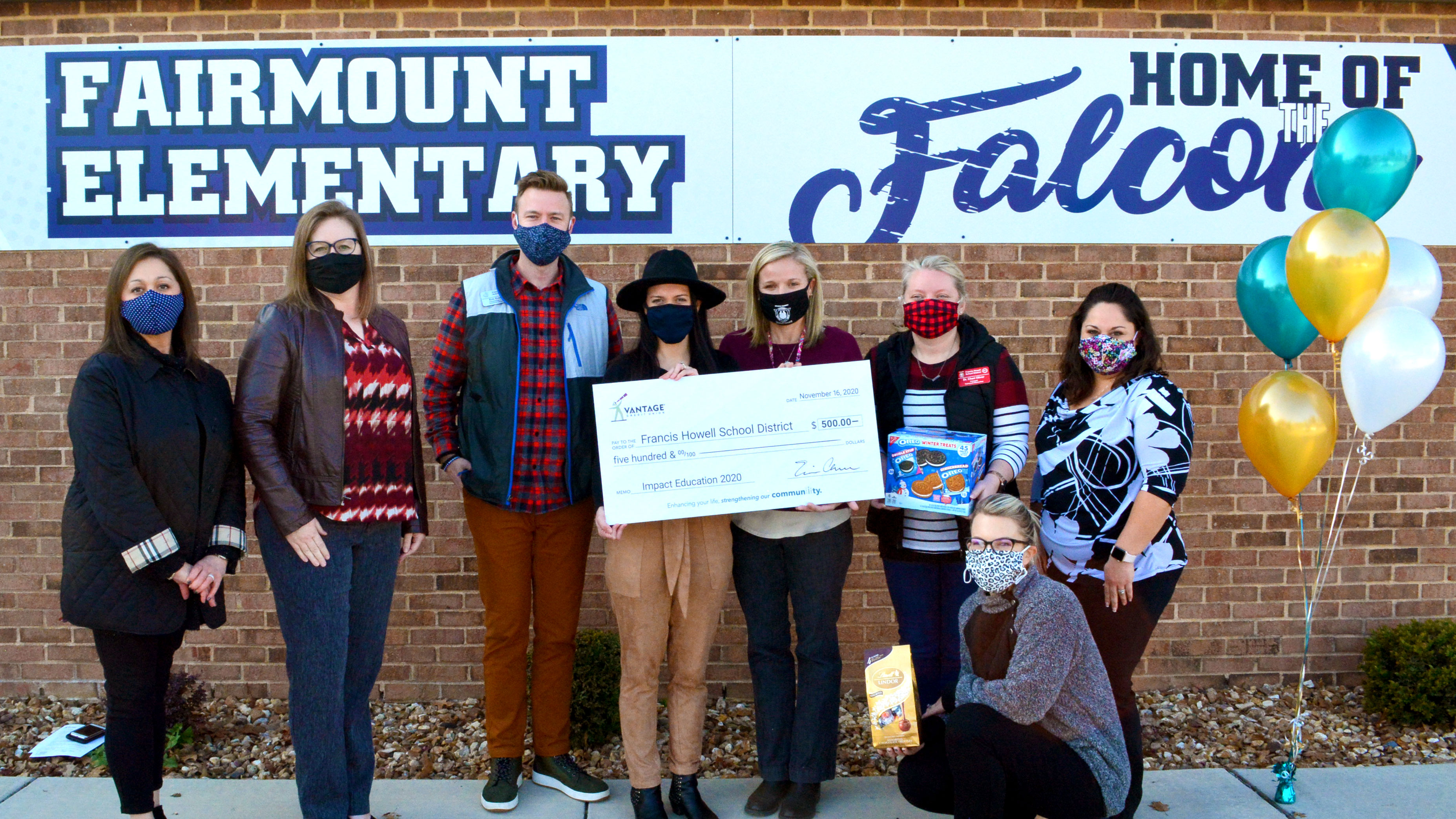 2020-news-catie-whitt A group of teachers holding a large check