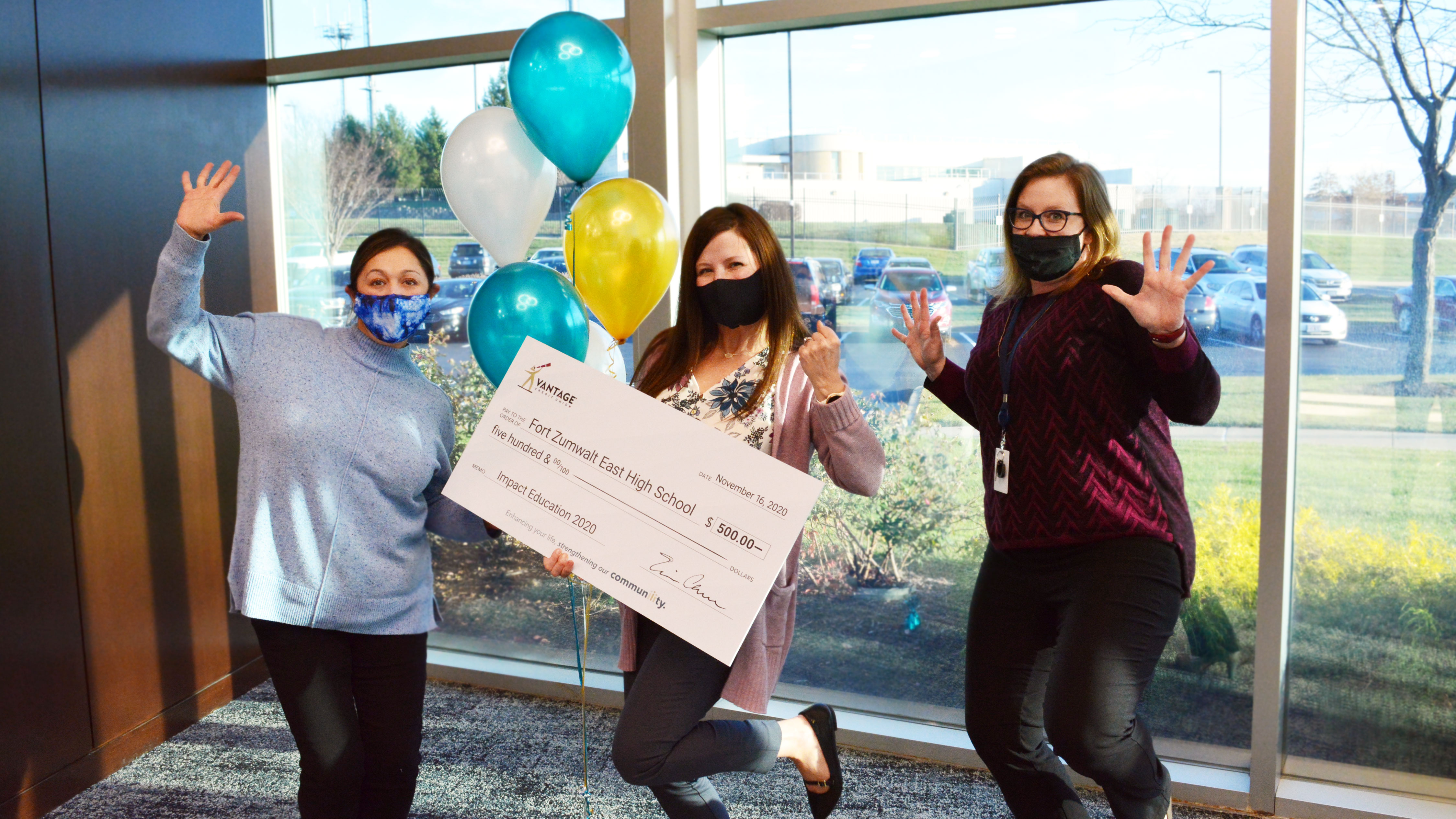 2020-news-samantha-vogler Three teachers holding a large check