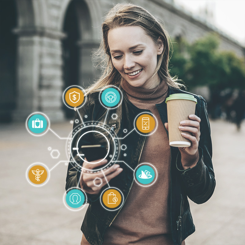 A woman holding her coffee looking at her phone