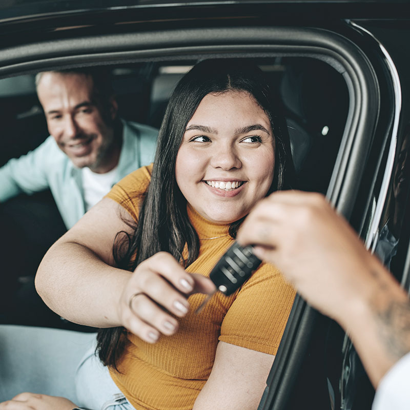 A woman getting the keys to her car
