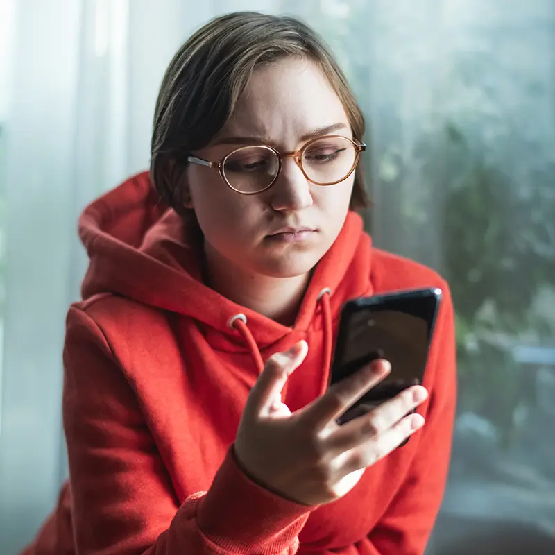 Concerned member looking at their phone