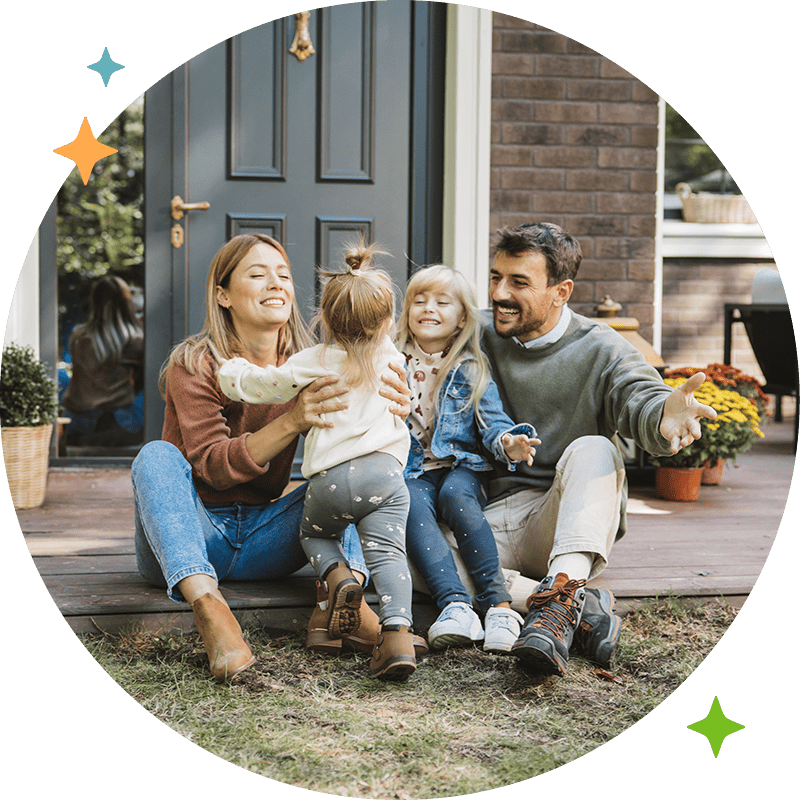 A family laughing and sitting on their front porch
