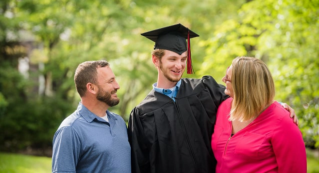 A family smiling after a school graduation