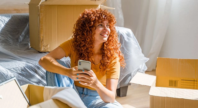 A woman unpacking boxes after moving