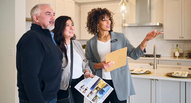 A realtor showing a couple a house
